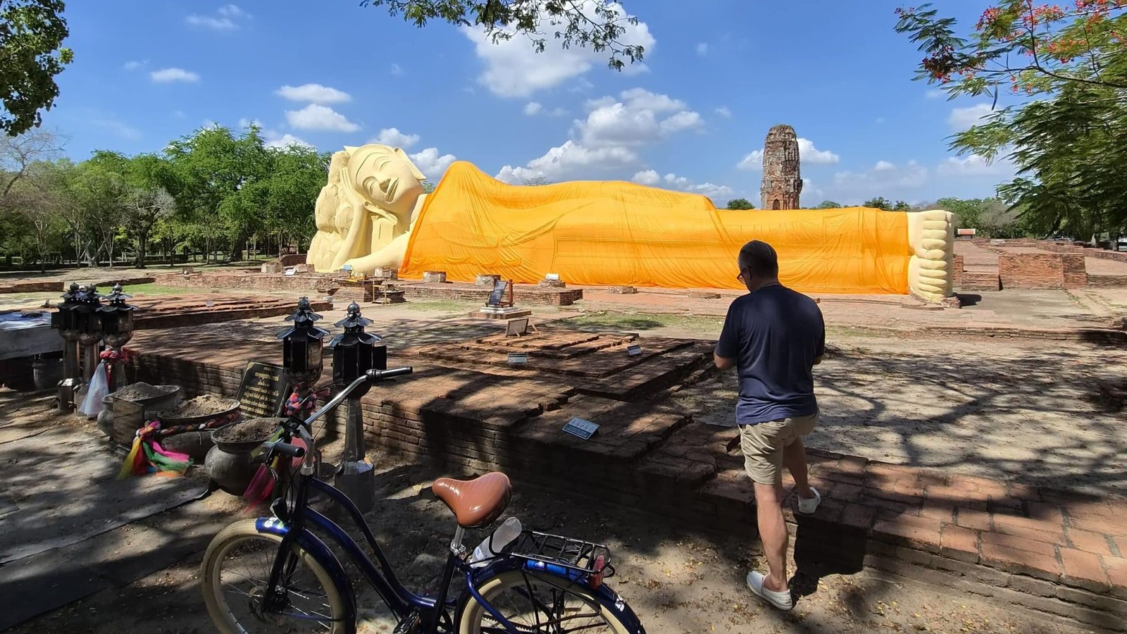 Travelers on an Ayutthaya bike tour near ancient temples at sunset