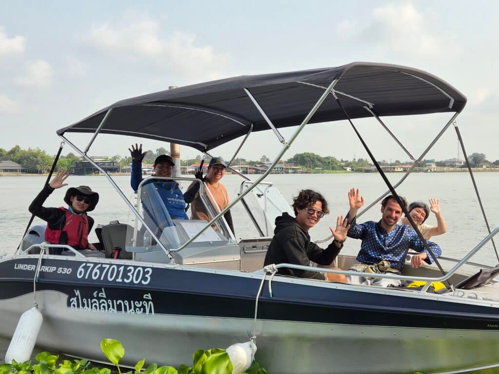 Guests and boat crew aboard a private motorboat on a Bangkok to Ayutthaya river tour.