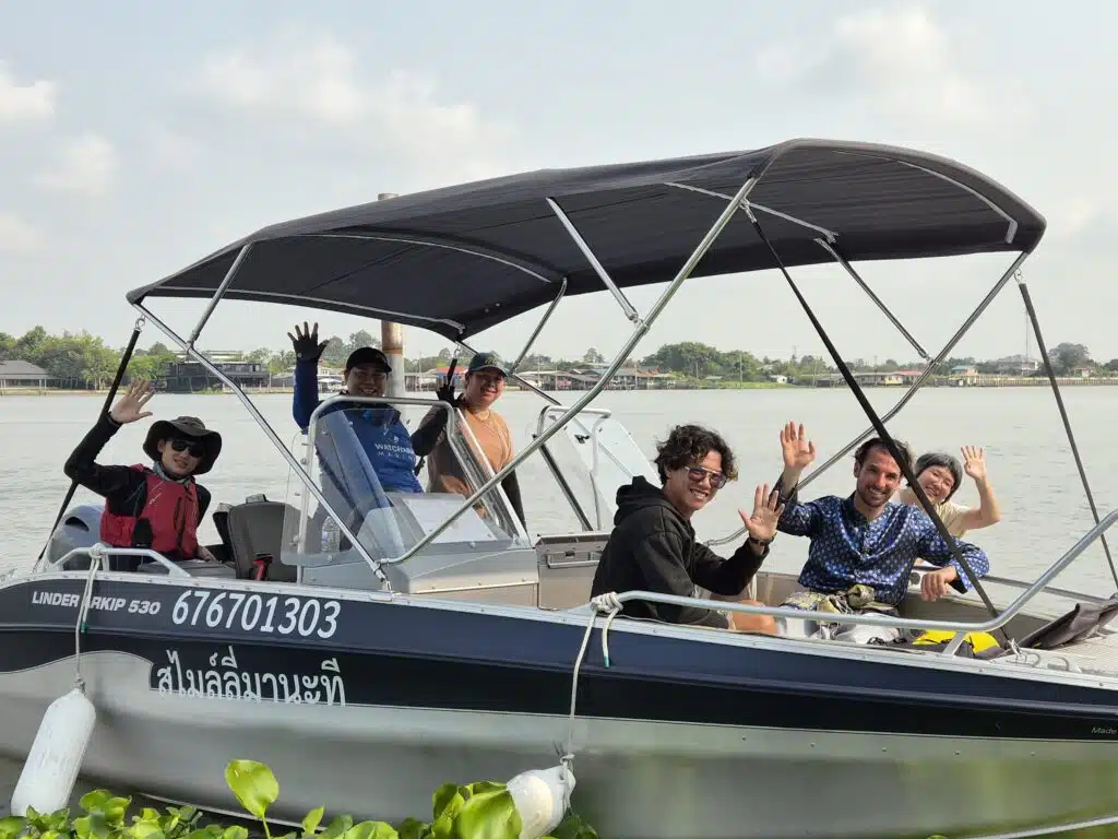 Guests and boat crew aboard a private motorboat on a Bangkok to Ayutthaya river tour.